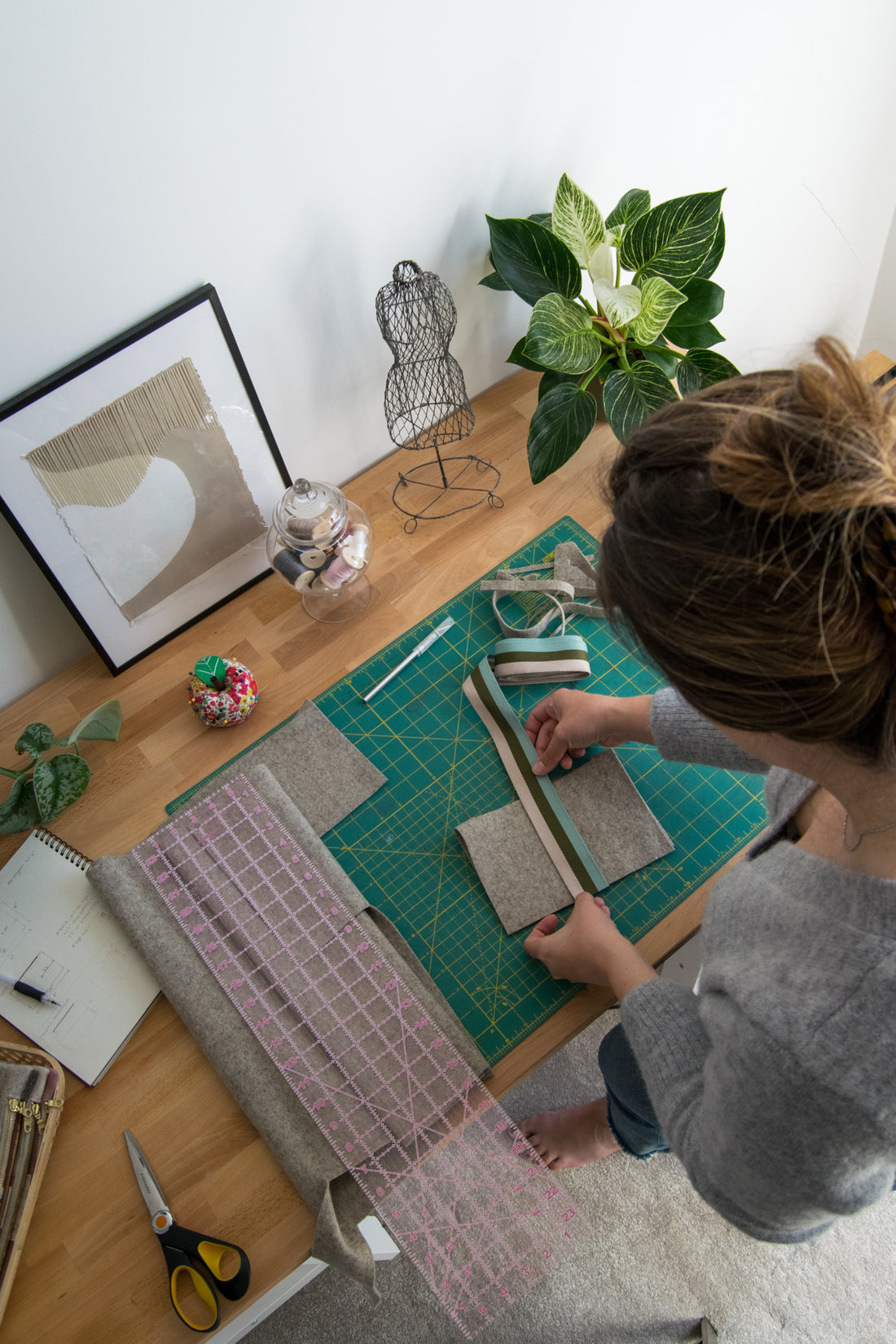 Julianna Cassata working on wool zip pouch in her studio.